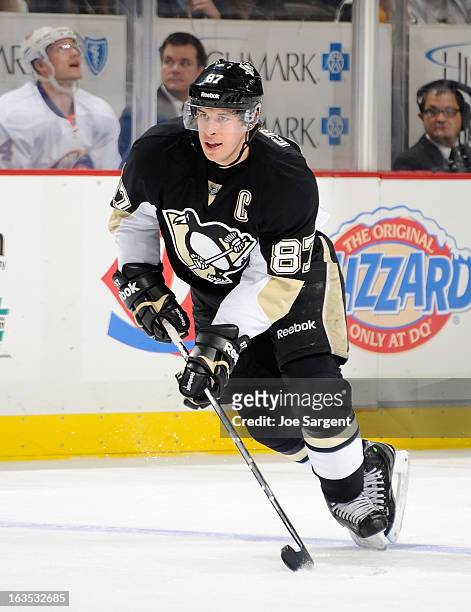 Sidney Crosby of the Pittsburgh Penguins controls the puck against the New York Islanders on March 10, 2013 at Consol Energy Center in Pittsburgh,...