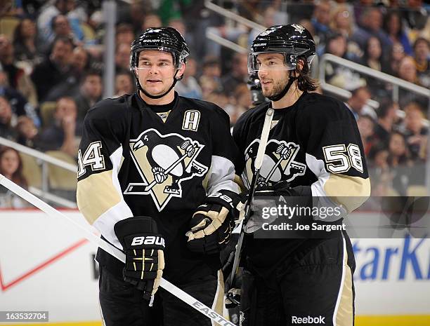 Chris Kunitz of the Pittsburgh Penguins talks with Kris Letang during the game against the New York Islanders on March 10, 2013 at Consol Energy...