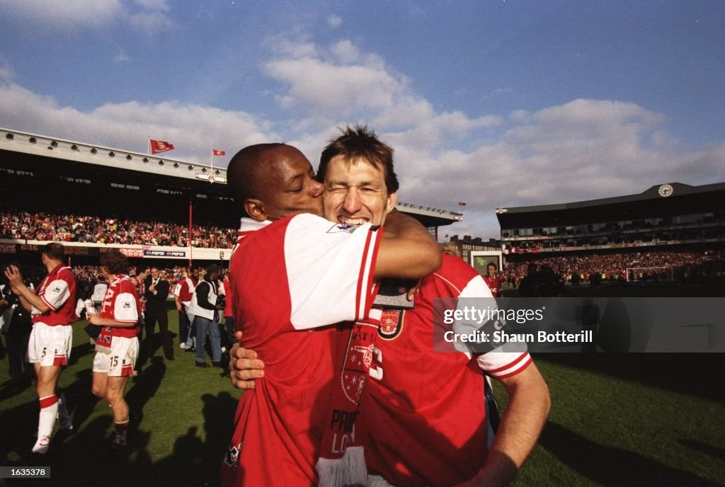Ian Wright of Arsenal kisses his captain Tony Adams