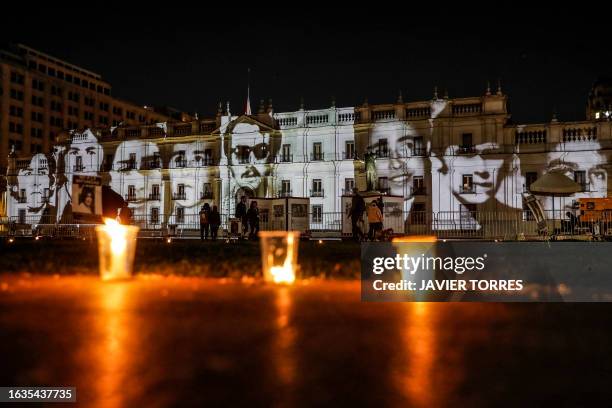 Images of disappeared detainees are projected on the facade of the Palacio de la Moneda in Santiago on August 30 the day on which Chile's President...