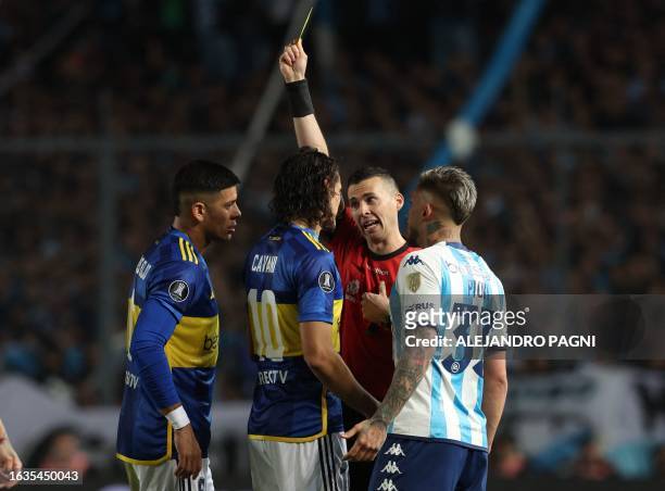 Uruguayan referee Andres Matonte yellow-cards Boca Juniors' Uruguayan forward Edinson Cavani and Racing's defender Gabriel Rojas , as Boca Juniors'...