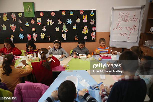 Schoolchildren, most of them ethnic Roma, have a hot lunch before afternoon activities that will include assisted homework in an after-school program...