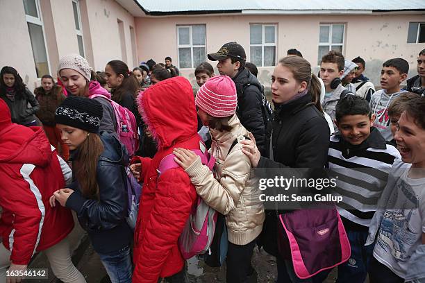 Schoolchildren, many of them ethnic Roma, arrive for school on March 11, 2013 in Dilga, Romania. Dilga is a settlement of 2,500 people with dirt...