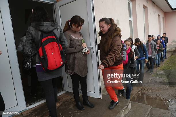 Schoolchildren, most of them ethnic Roma, arrive for school on March 11, 2013 in Dilga, Romania. Dilga is a settlement of 2,500 people with dirt...
