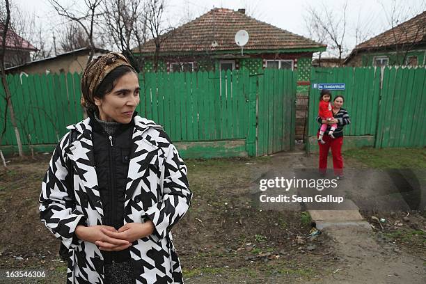 Ethnic Roma, including Viorica Gheorghe and her daughter Gabriela stand outside the Gheorghe home on March 11, 2013 in Dilga, Romania. Viorica's...