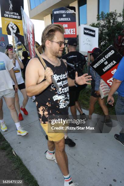 Adam Conover walks the picket line in support of the SAG-AFTRA and WGA strike on August 30, 2023 at Netflix Studios in Hollywood, California.