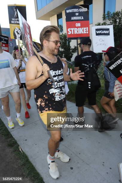 Adam Conover walks the picket line in support of the SAG-AFTRA and WGA strike on August 30, 2023 at Netflix Studios in Hollywood, California.