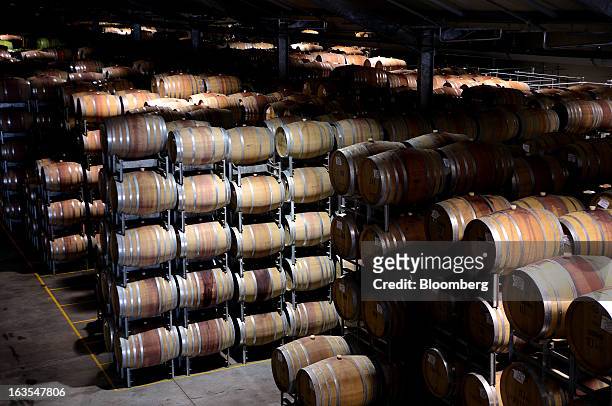Barrels of red wine are stacked for aging during secondary fermentation at Treasury Wine Estates Ltd.'s Wolf Blass winery in the Barossa Valley,...