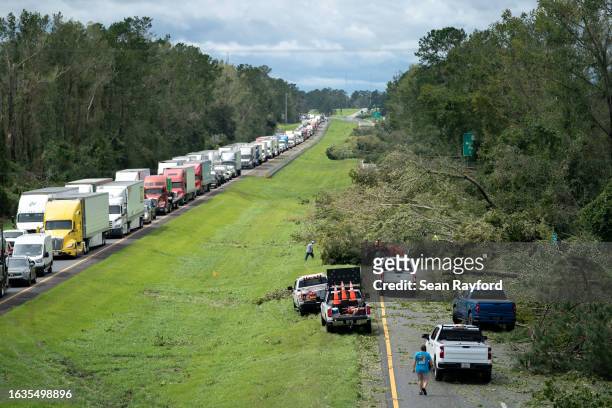 People work to clear I-10 of fallen trees after Hurricane Idalia crossed the state on August 30, 2023 near Madison, Florida. The storm made landfall...