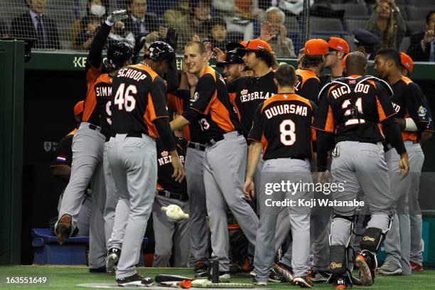 Infielder Andrelton Simmons of the Netherlands celebrates with team-mates after scoring a homerun in the top half of the first inning during the...