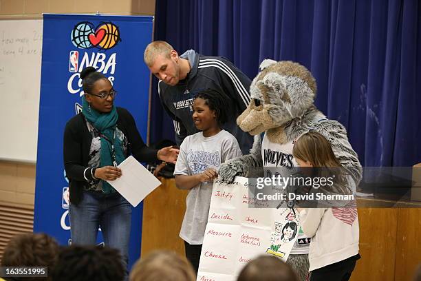 Greg Stiemsma and mascot Crunch of the Minnesota Timberwolves review the assignment at a Reading Timeout as part of the Minnesota Timberwolves...