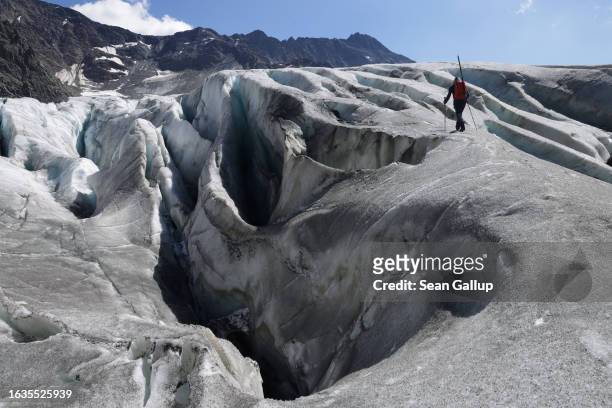 Martin Stocker-Waldhuber, a glaciologist with the Institute for Interdisciplinary Mountain Research of the Austrian Academy of Sciences, walks past...