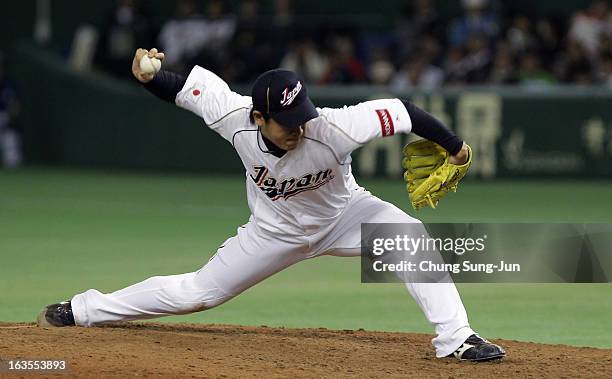 Pitcher Kazuhisa Makita of Japan pitches in the ninth inning during the World Baseball Classic Second Round Pool 1 game between Japan and the...