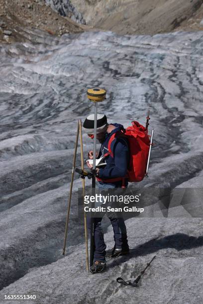 Martin Stocker-Waldhuber, a glaciologist with the Institute for Interdisciplinary Mountain Research of the Austrian Academy of Sciences, uses a GPS...