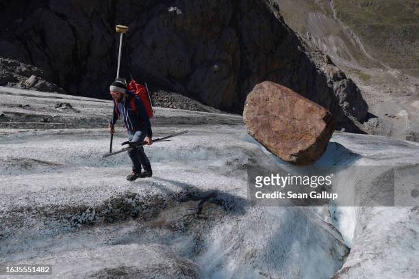 Martin Stocker-Waldhuber, a glaciologist with the Institute for Interdisciplinary Mountain Research of the Austrian Academy of Sciences, carries a...