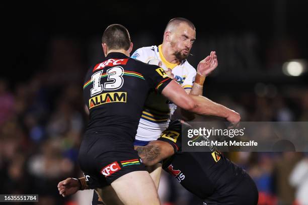 Clint Gutherson of the Eels is tackled by Isaah Yeo of the Panthers during the round 26 NRL match between Penrith Panthers and Parramatta Eels at...