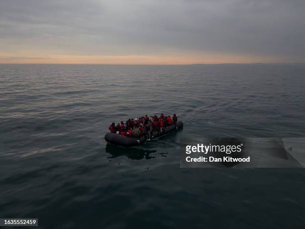 In this aerial view, A boat carrying around 50 migrants drifts into English waters after being trailed by a French emergency tug, the Abeille...