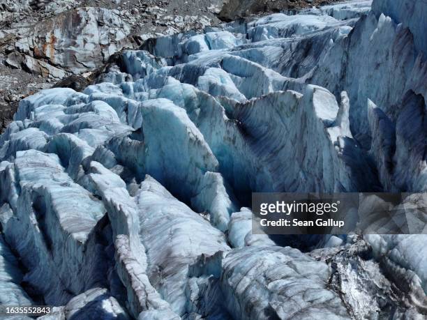 In this aerial view deep crevasses line the tongue of the melting Gepatschferner glacier descending on August 22, 2023 above Kaunertal, Austria....