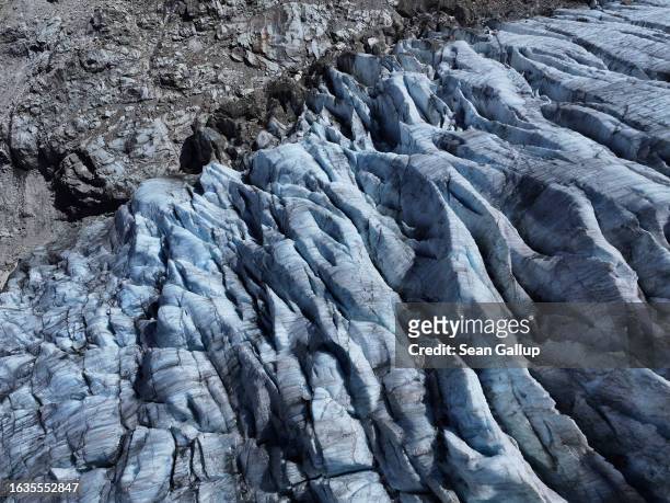 In this aerial view deep crevasses line the tongue of the melting Gepatschferner glacier descending on August 22, 2023 above Kaunertal, Austria....