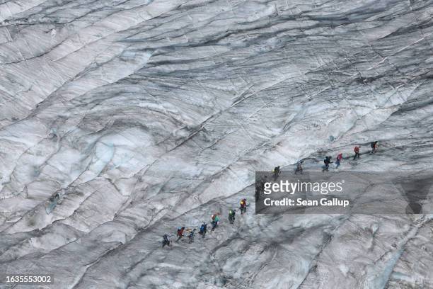 University geology students led by a mountain guide cross the tongue of the melting Gepatschferner glacier on August 22, 2023 above Kaunertal,...