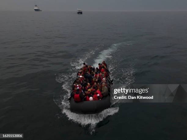 In this aerial view, A boat carrying around 50 migrants drifts into English waters after being escorted by a French emergency tug, the Abeille...