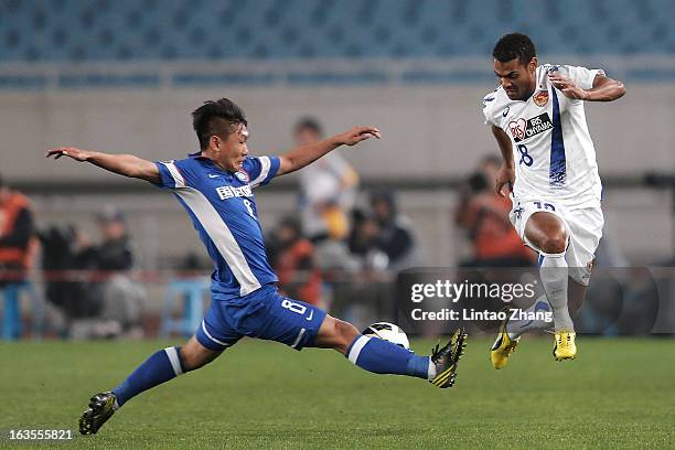 Liu Jianye of Jiangsu Sainty challenges Diogo of Vegalta Sendaion during the AFC Champions League match between Jiangsu Sainty and Vegalta Sendai at...