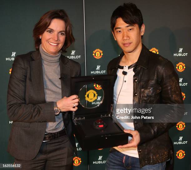 Shinji Kagawa of Manchester United is presented with a Hublot watch by Valerie Servageon Grande of Hublot watches before taking part in a charity...