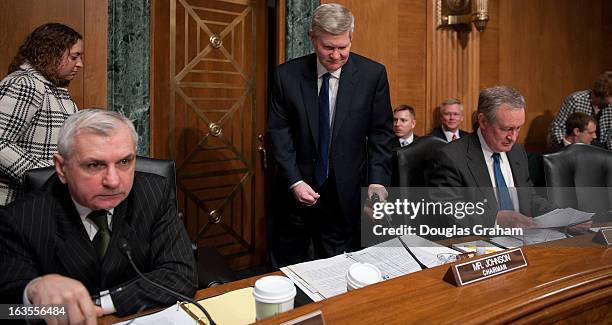 MARCh 12: Sen. Jack Reed, D-RI., Chairman Tim Johnson, D-SD., and Sen. Michael Crapo, R-ID., before the start of the full committee hearing on the...