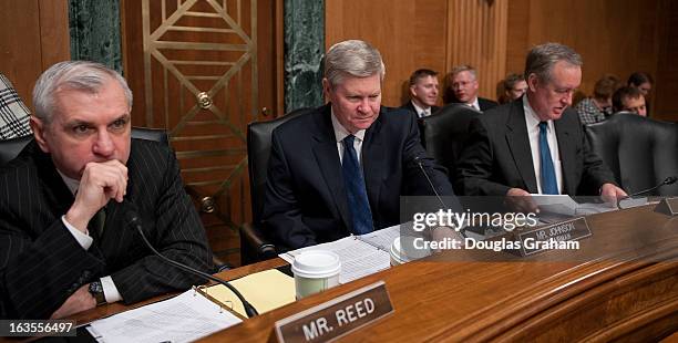 MARCh 12: Sen. Jack Reed, D-RI., Chairman Tim Johnson, D-SD., and Sen. Michael Crapo, R-ID., before the start of the full committee hearing on the...