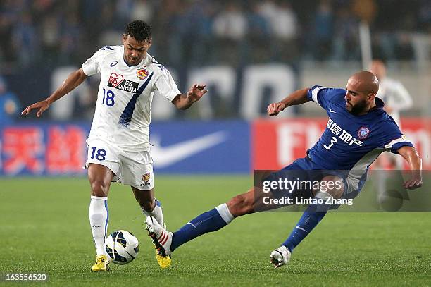 Wilson Rodrigues Fonseca of Vegalta Sendaion challenges Faras Eleilson and of Jiangsu Sainty during the AFC Champions League match between Jiangsu...