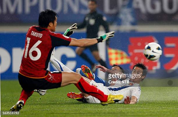 Japan Vegalta Sendai's goalkeeper Takuto Hayashi stops a shot from China Jiangsu Sainty's Zhou Yun during their AFC Champions League group E match at...