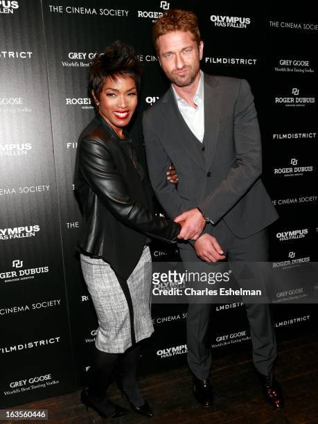 Actors Angela Bassett and Gerard Butler attend The Cinema Society with Roger Dubuis and Grey Goose screening of FilmDistrict's "Olympus Has Fallen"...
