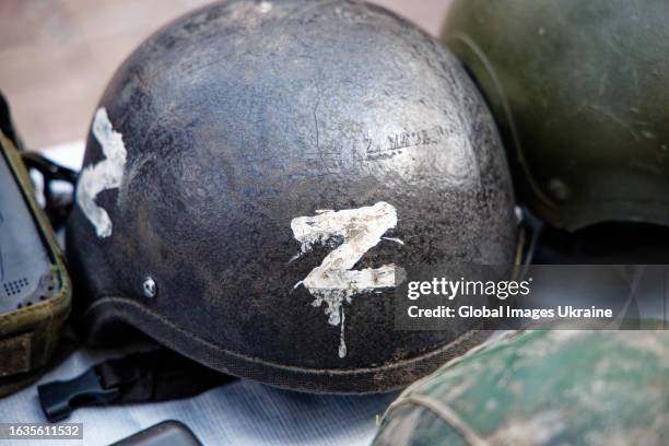 Combat Russian helmets, one of which is marked with Russian military symbol Z, are displayed on Khreschatyk Street during an exhibition on August 23,...
