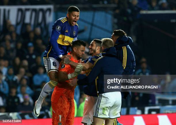 Boca Juniors' goalkeeper Sergio Romero celebrates with teammates after winning the penalty shoot-out of the all-Argentine Copa Libertadores...