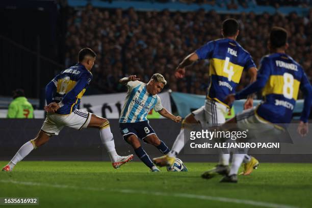 Racing's Colombian midfielder Juan Fernando Quintero strikes the ball as Boca Juniors' defender Marcos Rojo tries to block him during the...