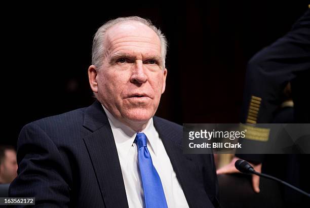 Director John Brennan takes his seat to testify during the Senate Intelligence Committee hearing on "Current and Projected National Security Threats...