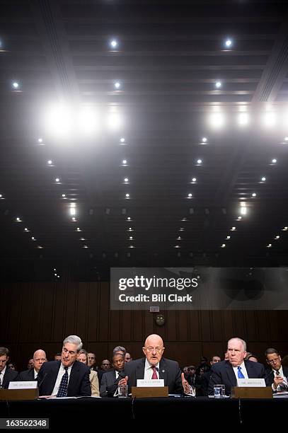 From left, FBI Director Robert Mueller, Director of National Intelligence James Clapper, and CIA Director John Brennan, testify during the Senate...