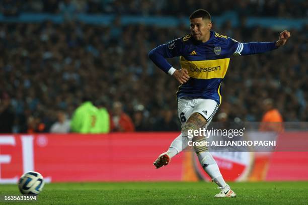 Boca Juniors' defender Marcos Rojo takes his shot to score and win the penalty shoot-out of the all-Argentine Copa Libertadores quarterfinals second...