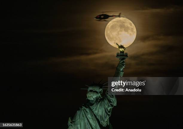 Supermoon rises over the Statue of Liberty in New York, USA on August 30, 2023.