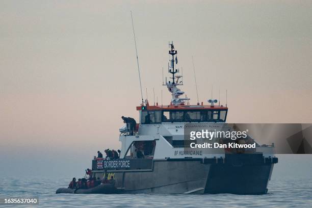 The BF Hurricane, a border force vessel arrives to collect around 50 migrants drifting into English waters after being accompanied by a French tug...