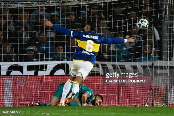 Boca Juniors' defender Marcos Rojo celebrates after scoring the last goal past Racing's Chilean goalkeeper Gabriel Arias during the penalty shoot-out...