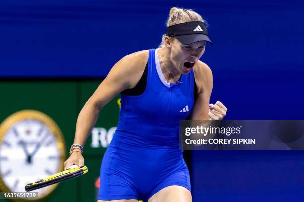 Denmark's Caroline Wozniacki reacts after a point won against Czech Republic's Petra Kvitova during the US Open tennis tournament women's singles...