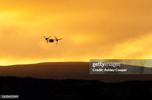 an osprey, a vertical take off and landing airplane flying at sunset over ambleside, lake district, uk. - plane taking off stock pictures, royalty-free photos & images