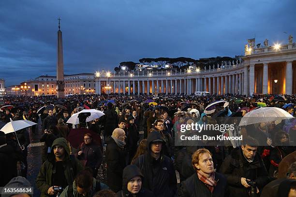People wait for an indication as to whether the College of Cardinals have elected a new Pope in St Peter's Square on March 12, 2013 in Vatican City,...