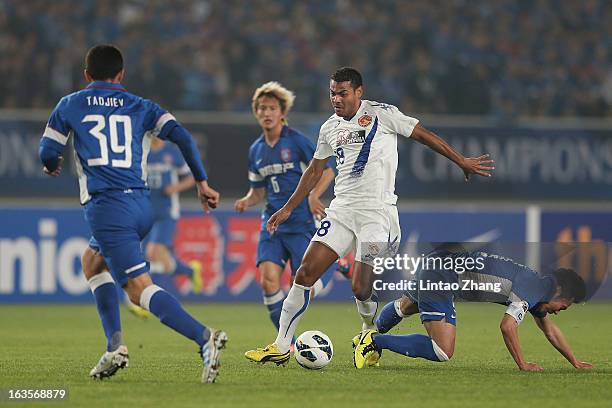 Wilson Rodrigues Fonseca of Vegalta Sendaion challenges Lu Bofei of Jiangsu Sainty during the AFC Champions League match between Jiangsu Sainty and...