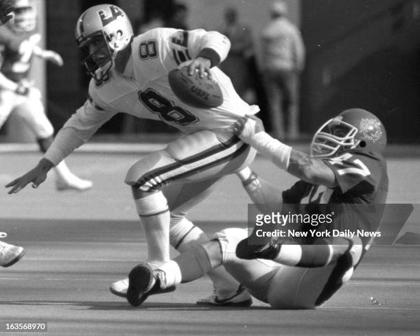 Football - NJ Generals vs LA Express - John Joyce manages to get grip on LA Express quarterback Steve Young and pull him down, but there was no...