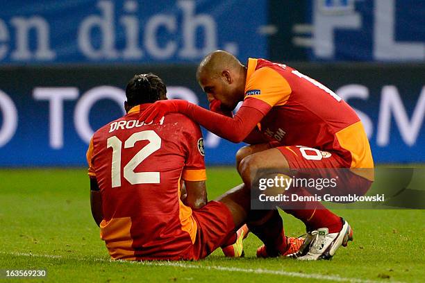 Felipe Melo of Galatasaray takes care of teammate Didier Drogba during the UEFA Champions League round of 16 second leg match between Schalke 04 and...