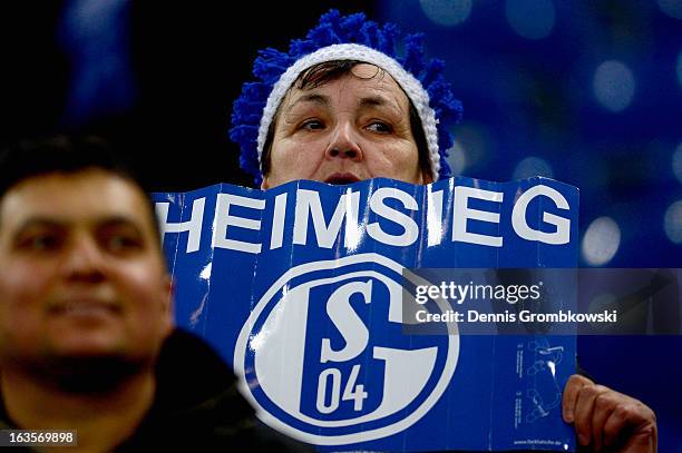 Schalke supporter looks on during the UEFA Champions League round of 16 second leg match between Schalke 04 and Galatasaray AS at Veltins-Arena on...