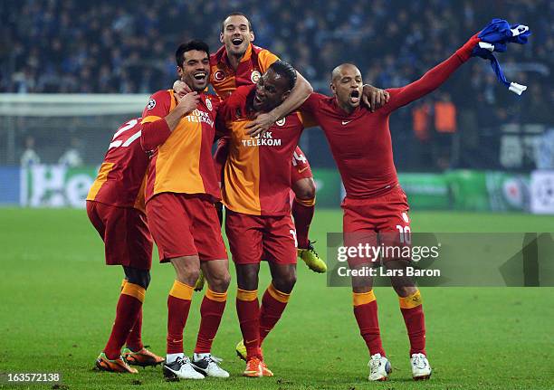 Wesley Sneijder and Didier Drogba of Galatasaray celebrate with team mates Goekhan Zan and Felipe Melo after winning the UEFA Champions League round...