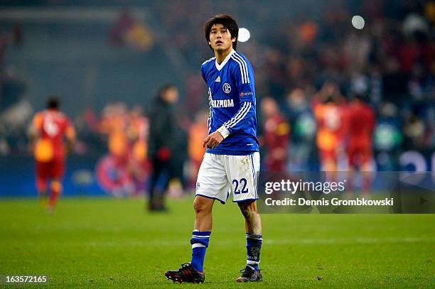 Atsuto Uchida of Schalke looks dejected after the UEFA Champions League round of 16 second leg match between Schalke 04 and Galatasaray AS at...